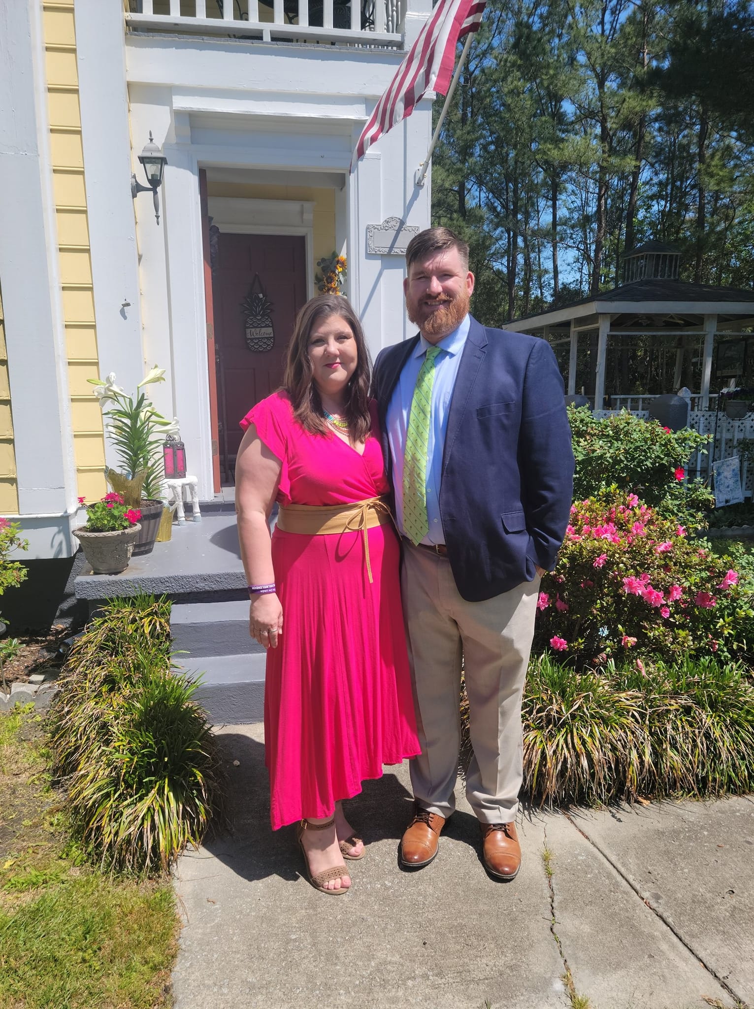 Natalie and Tommy pose in front of house