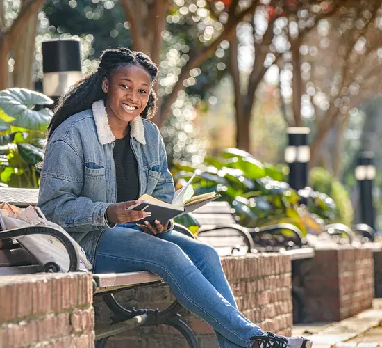 Image of girl sitting on campus bench